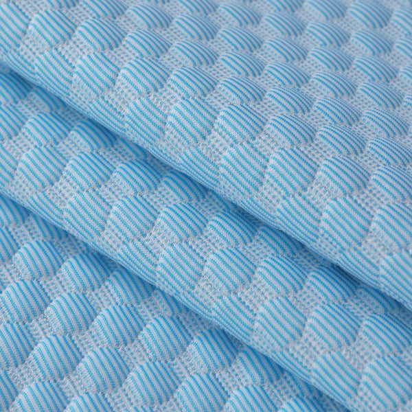 Light blue quilted fabric cover for a bean pillow, showing a diagonal fold.