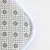 Close-up of a white anti-slip door mat with a black dot and floral pattern.