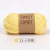 A ball of yellow sweet candy yarn labeled for crochet and knitting projects.