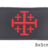 Black embroidered patch featuring a red cross design.