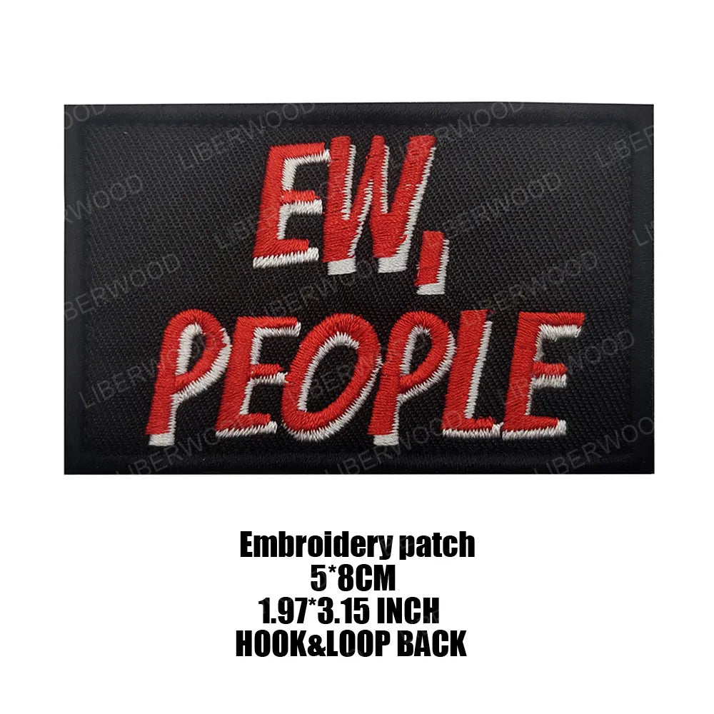 Black embroidered patch with red text reading EW PEOPLE