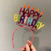 A sparkly birthday crown made of colorful felt shapes spelling out HAPPY BIRTHDAY