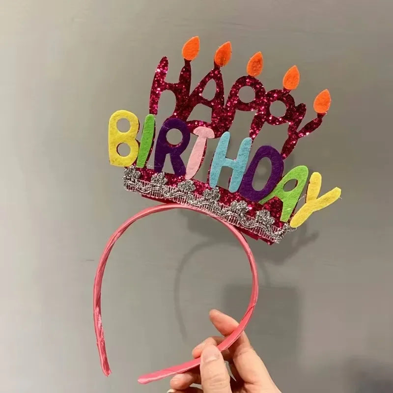 A sparkly birthday crown made of colorful felt shapes spelling out HAPPY BIRTHDAY
