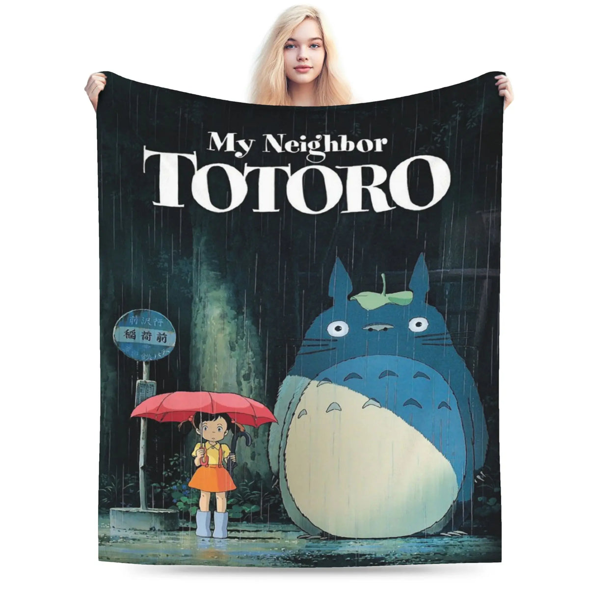 A poster featuring the Totoro character in the rain, with a woman holding it.