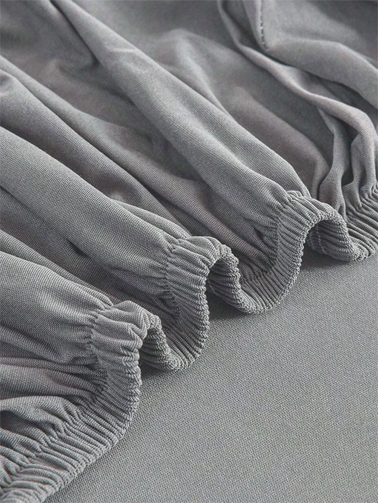 Gray elastic sofa slipcover fabric gathered and folded