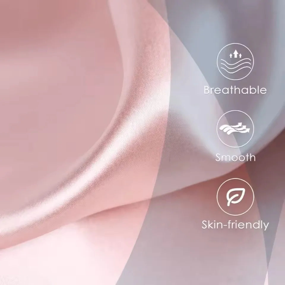 Close-up of a pink satin silk fabric with icons highlighting breathable smooth and skin-friendly features.