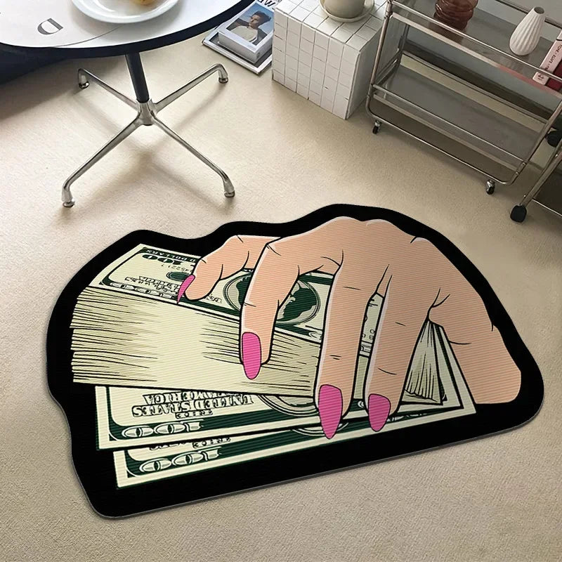 A hand is holding a stack of US dollar bills on a black rug.