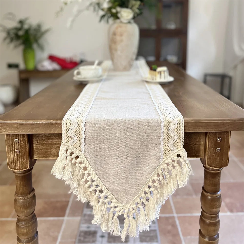 A beige crochet macrame lace table runner displayed on a wooden dining table.