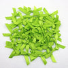 A pile of bright lime green satin ribbon bows for crafts and decor.