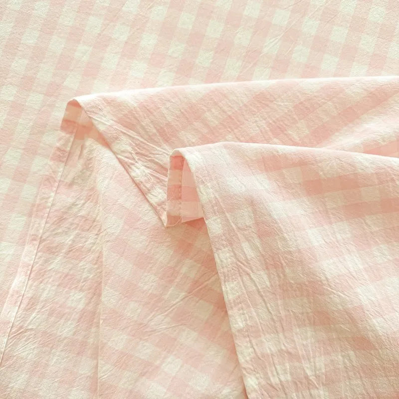 Pink organic cotton bedding set featuring a subtle checkered pattern in soft pink tones.
