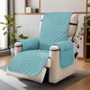 A teal washable slipcover is fitted onto a white recliner sofa with black straps, resting on a gray rug.