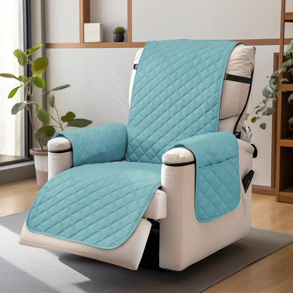 A teal washable slipcover is fitted onto a white recliner sofa with black straps, resting on a gray rug.