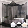 Elegant mosquito netting canopy draped over a bed in a bedroom setting.