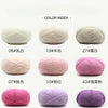 A collection of pink and white organic cotton knitting yarn skeins shown in various colors and textures.