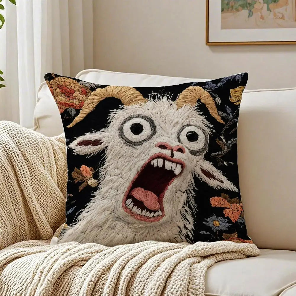 A black pillow featuring a white goat with wide eyes and an open mouth screaming expression