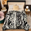A black and white patterned plush mink fleece king size blanket displayed on a bed.