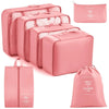 A set of pink travel storage organizers including a zippered pouch and several rectangular storage boxes.