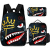 A set of three graphic print backpacks featuring a crown and a fierce tooth design on black fabric.