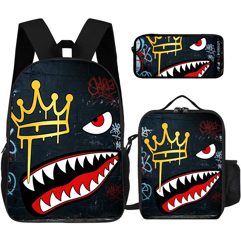 A set of three graphic print backpacks featuring a crown and a fierce tooth design on black fabric.