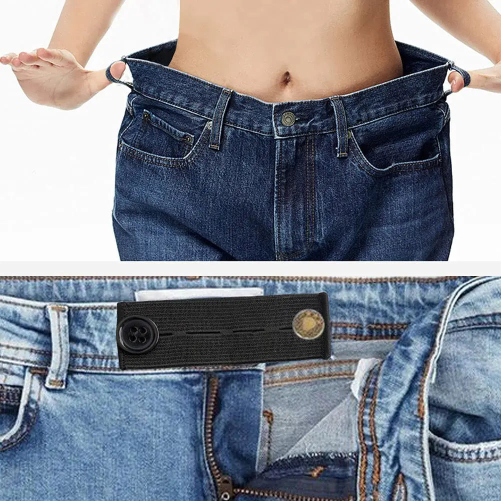 A close-up of a black elastic belt extender being placed inside the waistband of blue denim jeans.