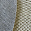 Close-up of a sisal runner rug showing the texture and woven pattern in gray and beige tones.