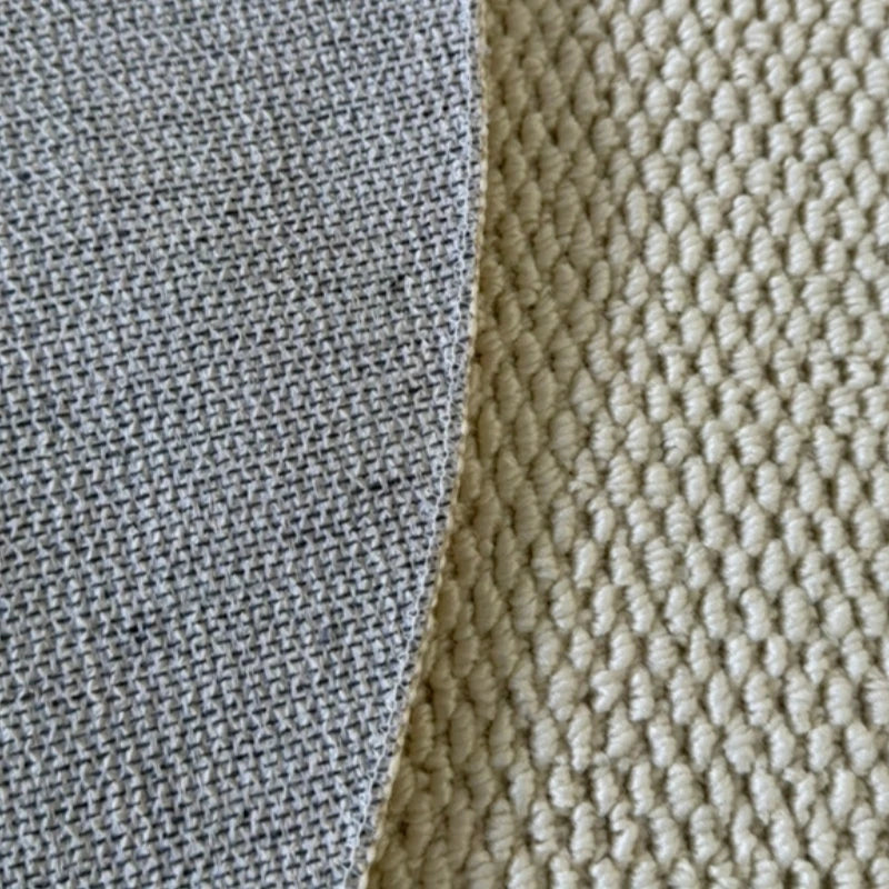 Close-up of a sisal runner rug showing the texture and woven pattern in gray and beige tones.