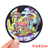 Colorful embroidered patch featuring mushrooms and foliage on a black fabric background
