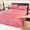 Pink thickened winter fitted bed sheets on a bed with a black headboard
