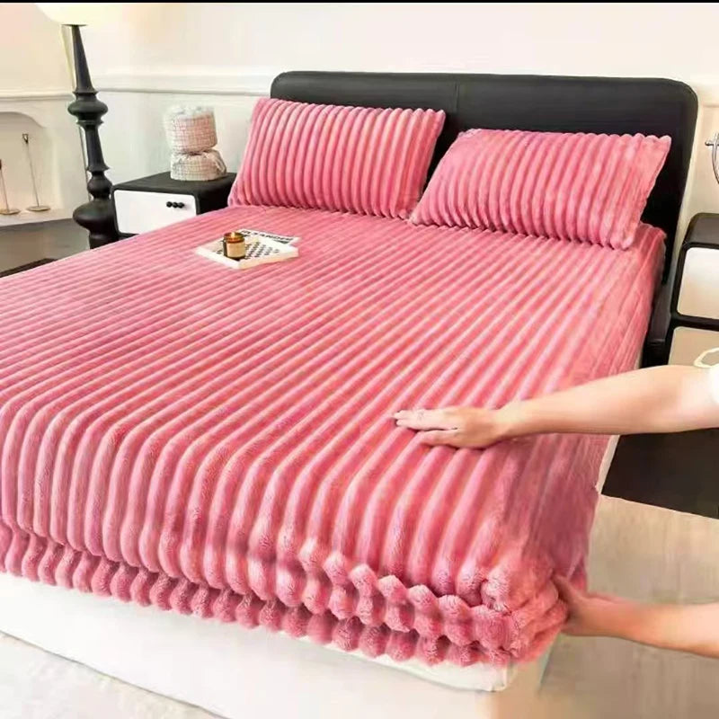 Pink thickened winter fitted bed sheets on a bed with a black headboard