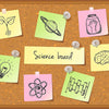 A collection of colorful sticky notes displaying various science concepts like a lightbulb, atom, and brain on an orange back