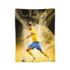 A football player in a yellow jersey and blue shorts is shown against a background featuring a silhouette of Ronaldo.