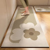 A beige kitchen floor mat with a large floral design is placed on a light wood floor.
