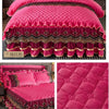 Pink quilted velvet bed skirt with gold trim and piping for a luxurious bedroom setting