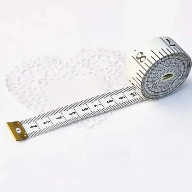 A flexible fiberglass body measuring tape coiled on a white background with markings.