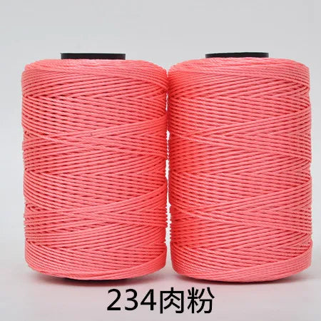 Two spools of bright coral pink hand knitting and crochet cord for crafting