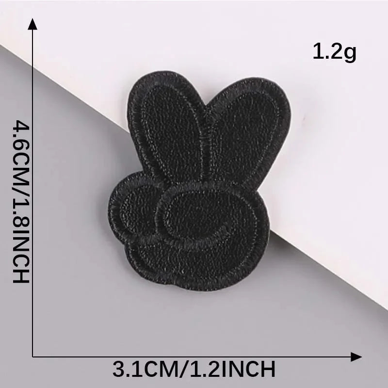 A black embroidered leather patch shaped like a bee, measuring 4.6cm by 3.1cm.