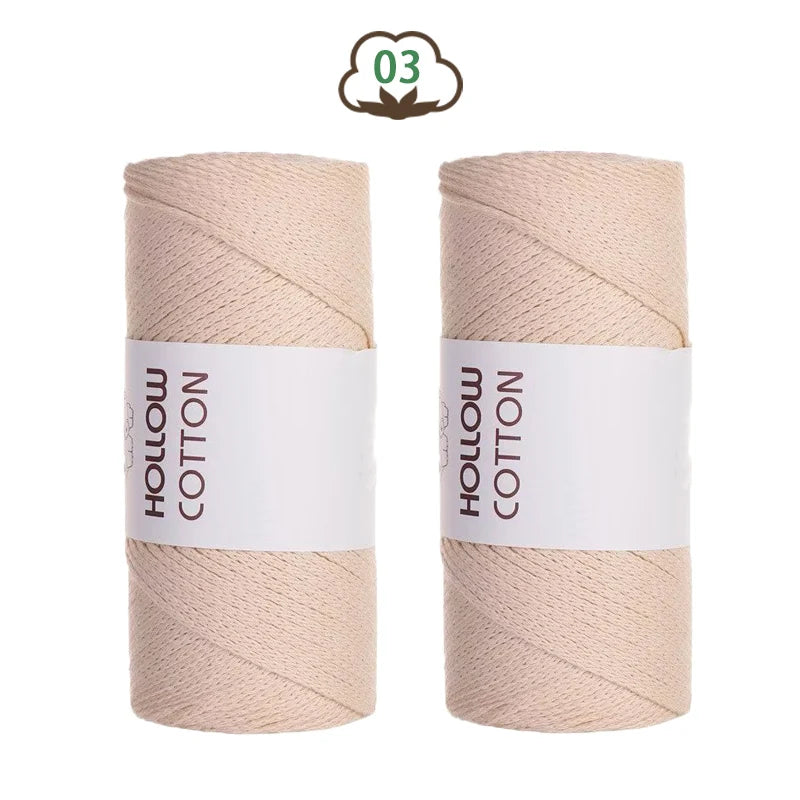 Two spools of light beige hollow cotton yarn for DIY crafting