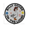 Black embroidery patch featuring a goose wearing a hat and text reading Silly Goose on the loose