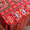 Close-up of red and blue bohemian printed linen fabric with geometric patterns for home decor