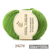 A ball of bright green wool thread labeled as Wool Thread delicate and soft intimate warmth