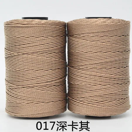 Two spools of beige hand knitting and crochet cord for crafting