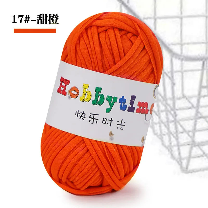 A ball of bright orange thick polyester craft yarn for knitting and crochet