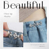 Close up display of silver adjustable waist clip brooches used to decorate denim fabric.