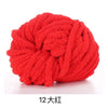A ball of bright red chunky acrylic yarn for knitting and crochet projects.