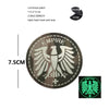 A round, dark embroidered patch featuring a white eagle shield design with the word EMPIRE and a cross.