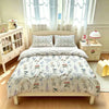 A hand-painted floral duvet cover set displayed on a bed with sheer curtains and a wooden dresser.
