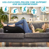 A woman is lying on a couch using a black inflatable leg elevation pillow for pain relief and decompression.