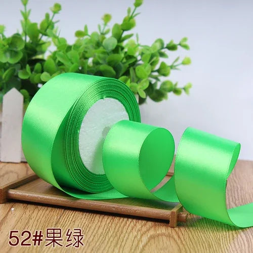 Roll of bright green satin ribbon for gift wrapping and DIY crafts