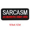 Black embroidered patch with white text saying SARCASM JUST ANOTHER FREE SERVICE I OFFER