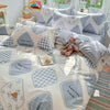 A light pink duvet and pillow set featuring a pattern of happy little friends and gingham designs.